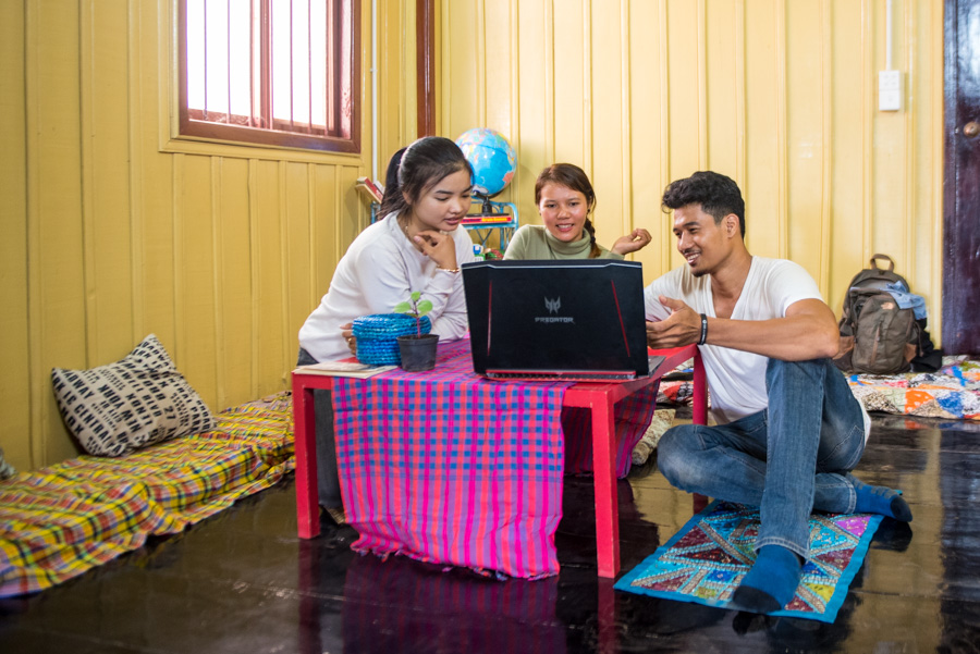 Young Cambodian man and two young women work together on a computer